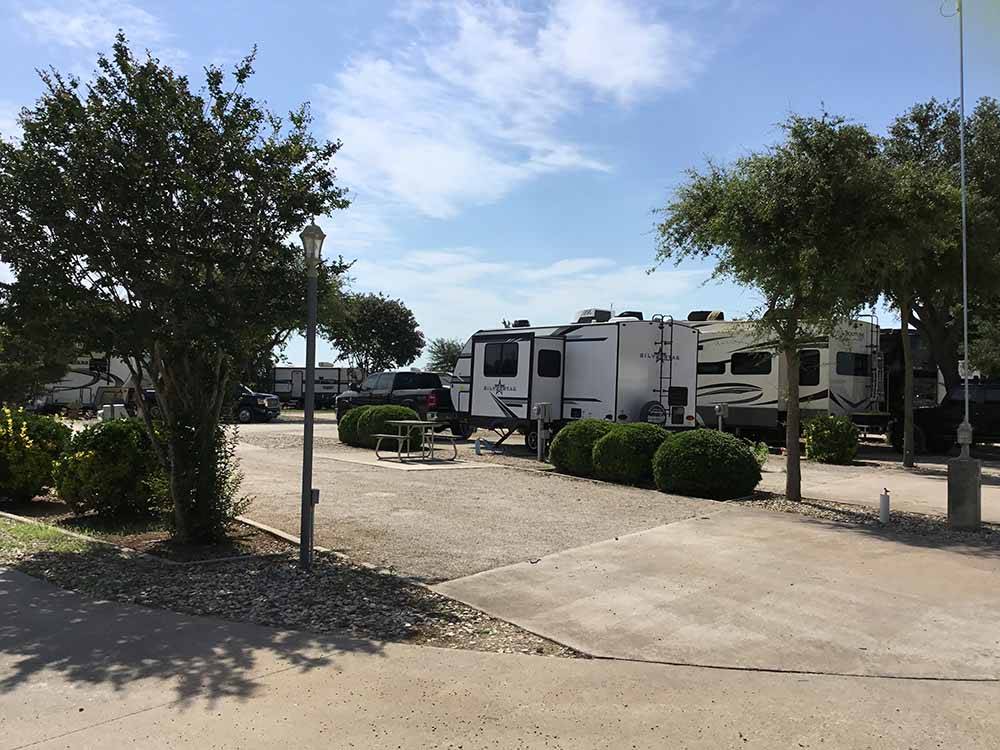 A row of gravel RV sites at NEW LIFE RV PARK