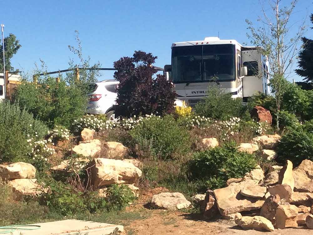 An RV site surrounded by bushes at BLUE MOUNTAIN RV AND TRADING