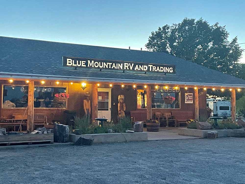 The main building with lights around the roof at BLUE MOUNTAIN RV AND TRADING