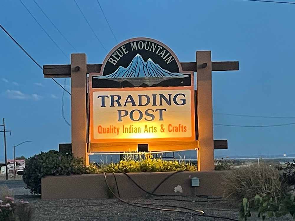 The lit up entrance sign at BLUE MOUNTAIN RV AND TRADING