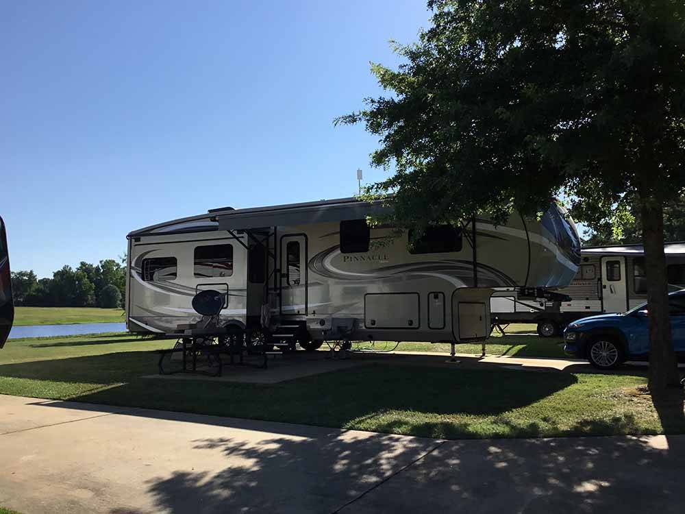 A fifth wheel trailer in a RV site at SHADY PINES RV PARK