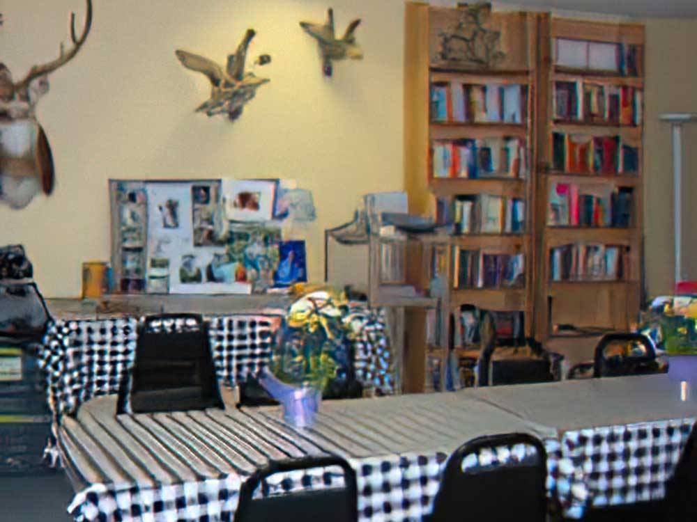 Long tables and a selection of books at ARROWHEAD CAMPGROUND