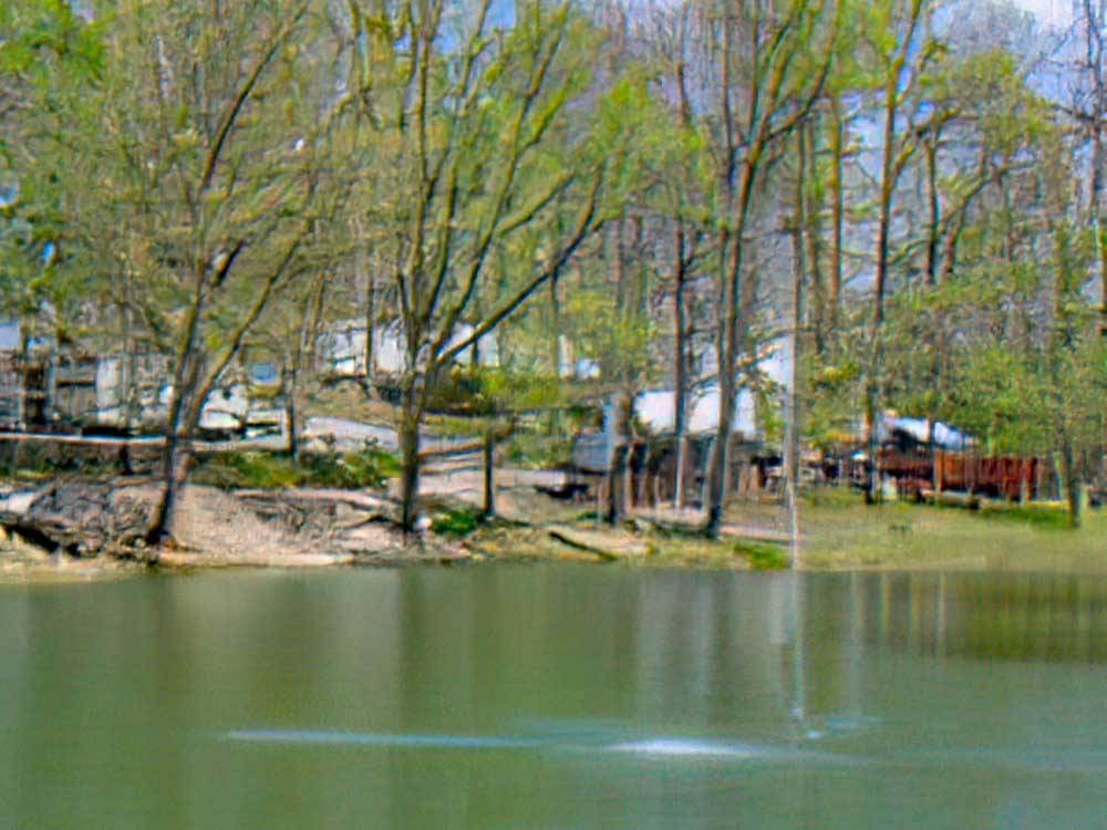 RVs parked near water's edge at ARROWHEAD CAMPGROUND