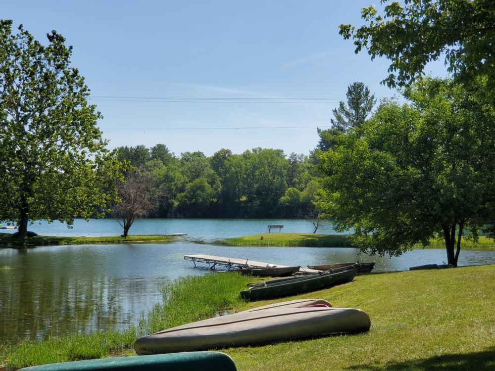 Canoes on the grass by the water