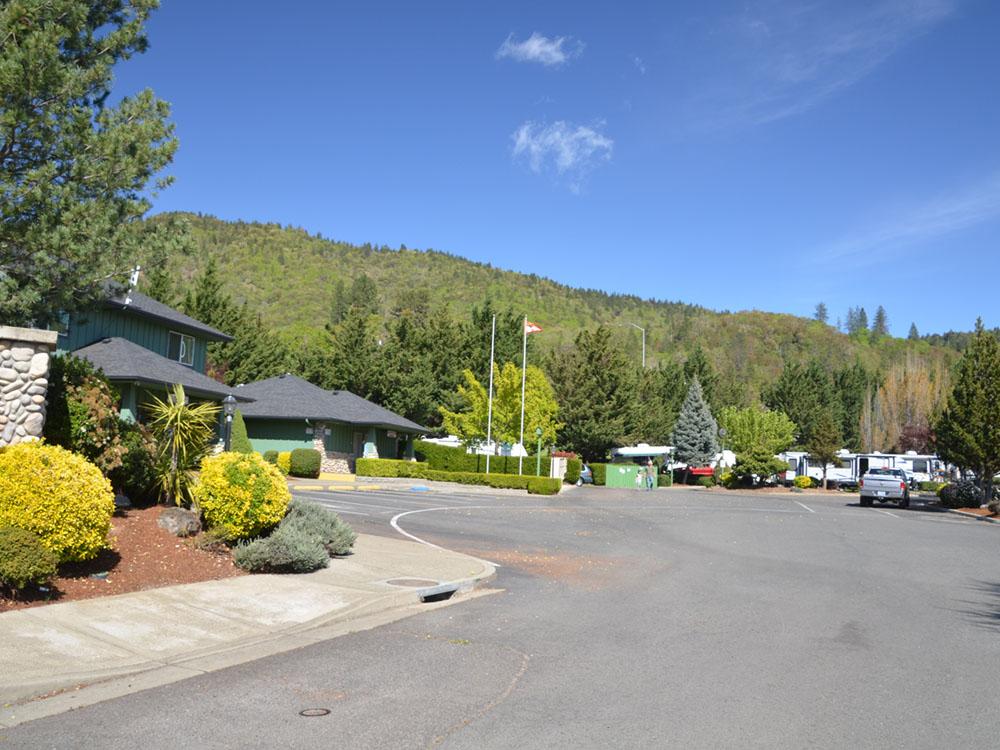 View of treed hillside from park entrance at JACK'S LANDING RV RESORT