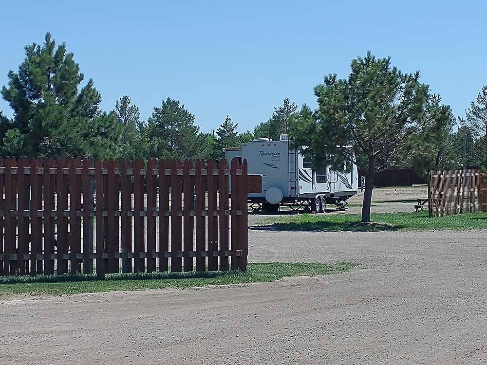 Small travel trailer parked at campsite at NORTH PARK RV CAMPGROUND