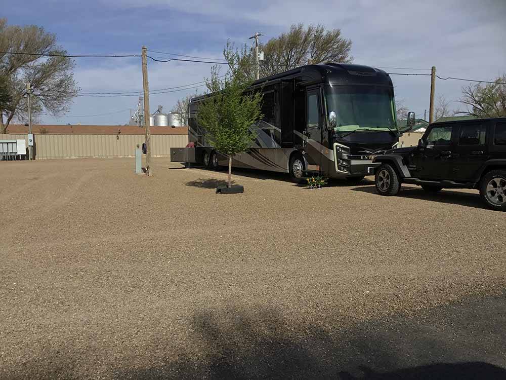A motorhome in a gravel RV site at CORRAL RV PARK