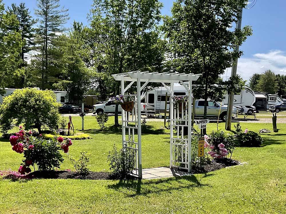 An arbor with roses surrounding it at PUMPKIN PATCH RV RESORT