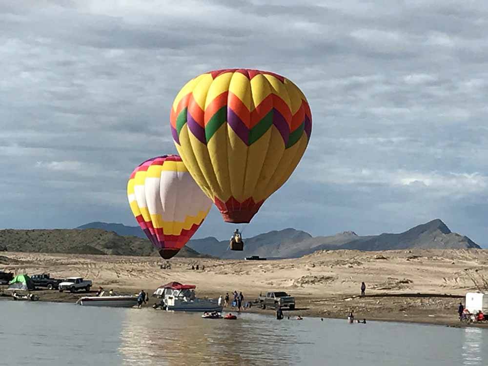 Hot air balloons over water at CEDAR COVE RV PARK
