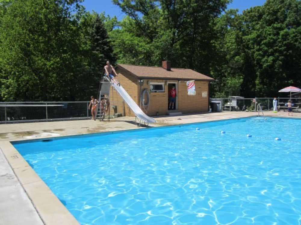The swimming pool with a slide at FOX DEN ACRES CAMPGROUND