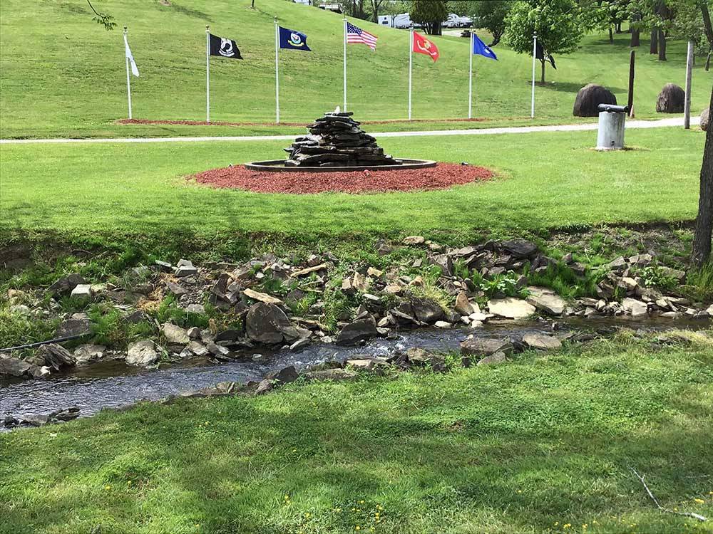 A water fountain and flag poles at FOX DEN ACRES CAMPGROUND
