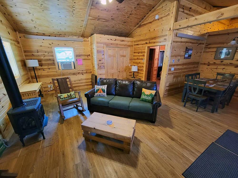 Cabin living room and dining area at Custer's Gulch RV Park & Campground