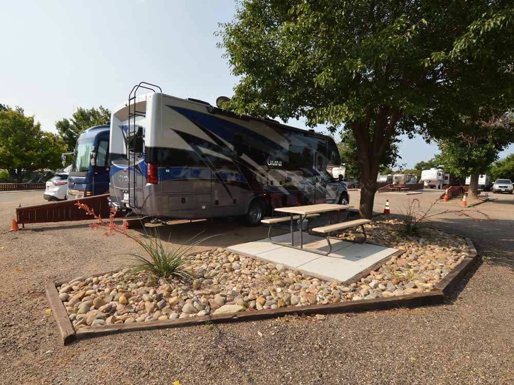 A motorhome in a pull thru RV site at FORT AMARILLO RV RESORT