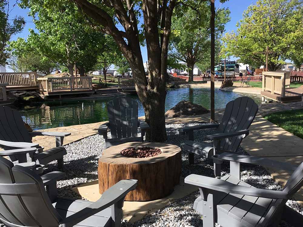 Lounge chairs around a fire pit at FORT AMARILLO RV RESORT