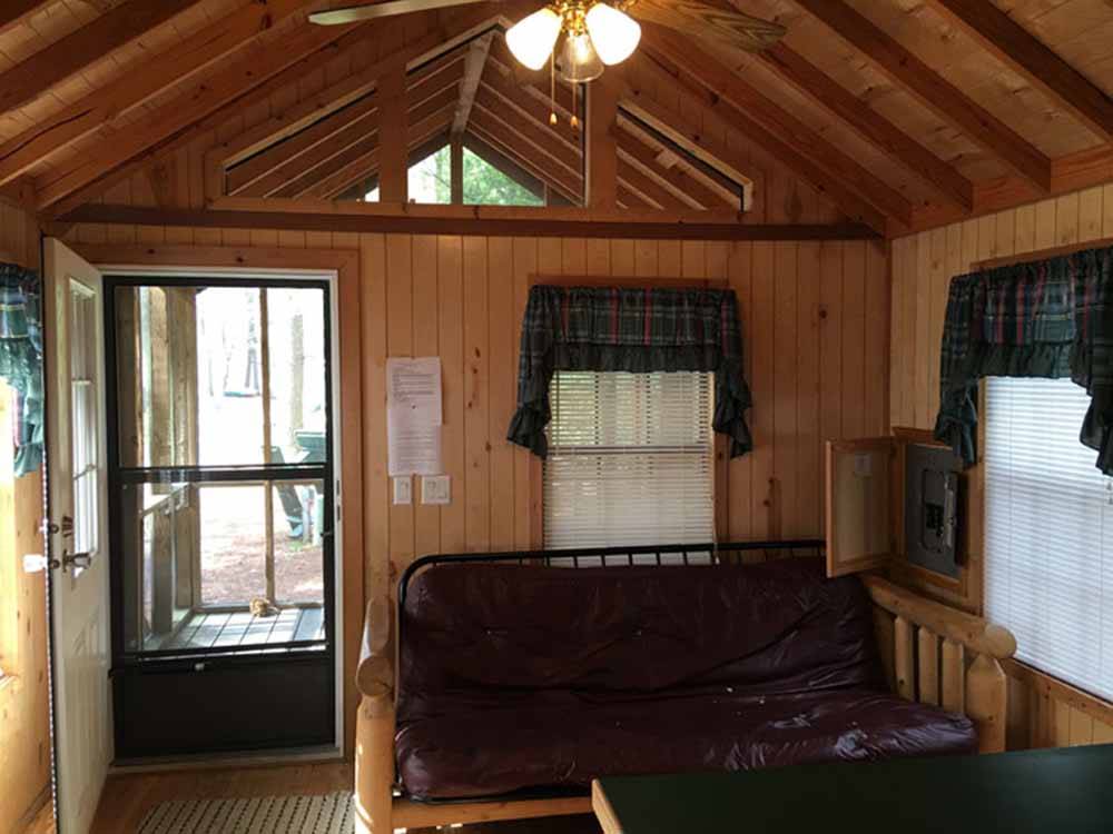 The living room area in a cabin rental at SCHROON RIVER CAMPGROUND & LODGING