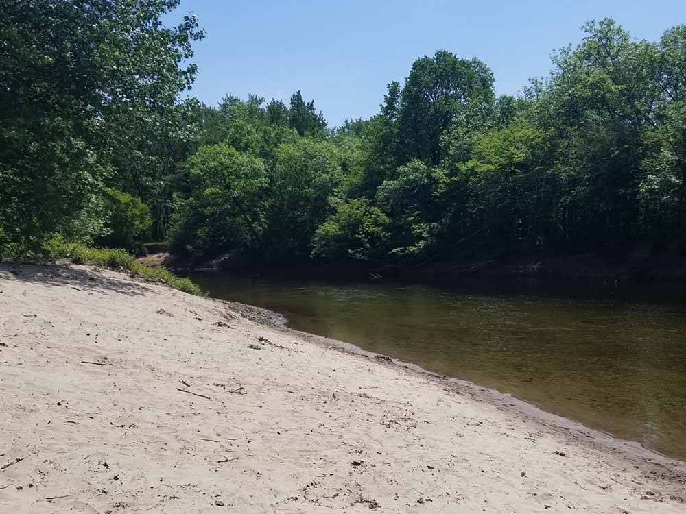 Sand next to the river at SCHROON RIVER CAMPGROUND & LODGING