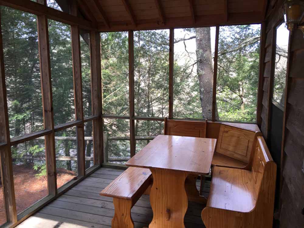 A nook on the deck of a cabin at SCHROON RIVER CAMPGROUND & LODGING