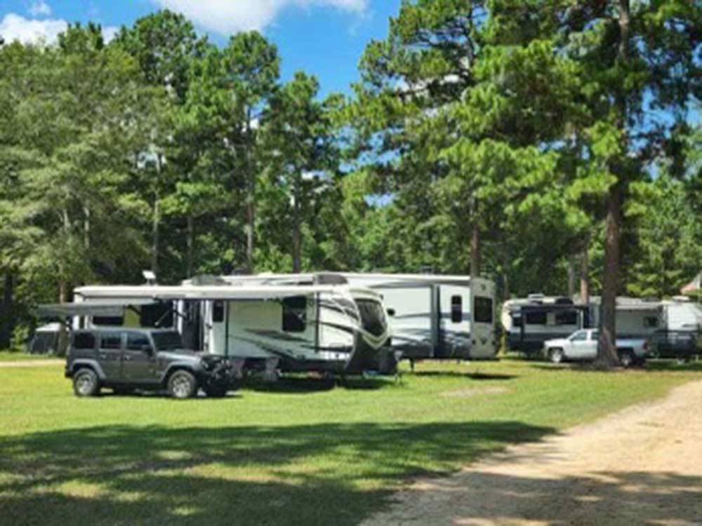 Cars and trailers parked on grassy sites at EDMUND RV PARK