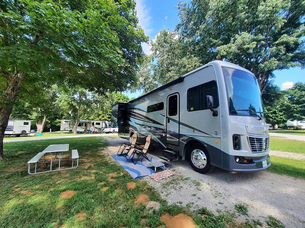 A motorhome in an RV site at WHITE ACRES CAMPGROUND