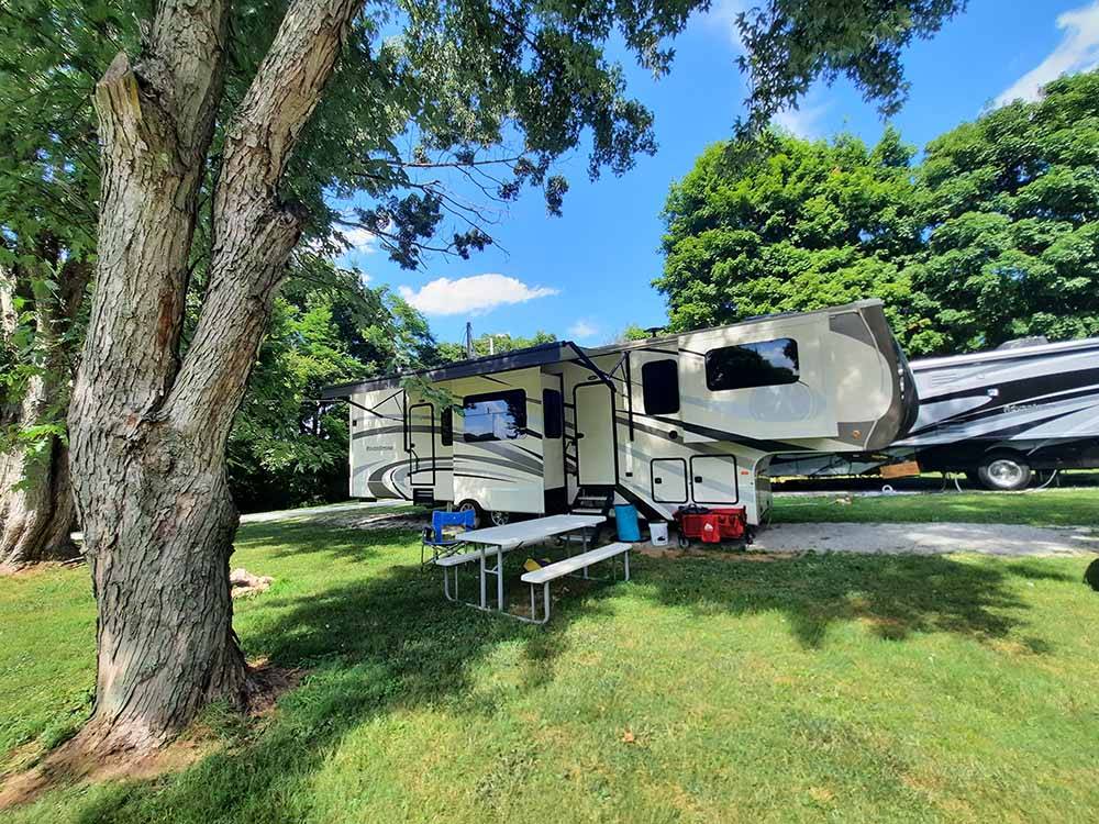 A fifth wheel trailer in an RV site at WHITE ACRES CAMPGROUND