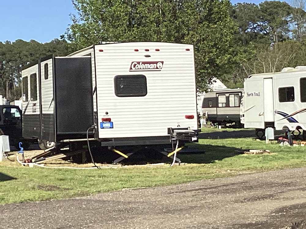 A travel trailer in a gravel RV site at MEMPHIS-SOUTH RV PARK & CAMPGROUND