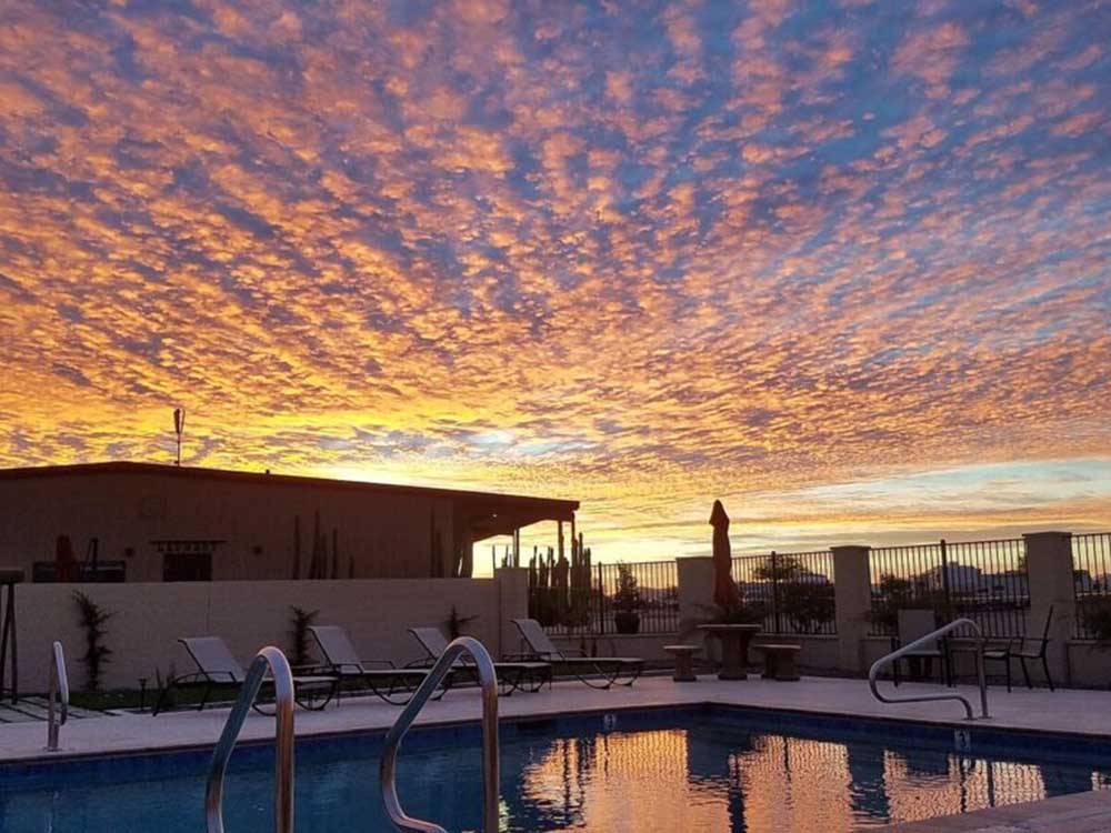 The swimming pool at sunset at SONORAN DESERT RV PARK