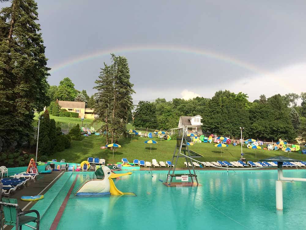A rainbow over the swimming pool at PINE COVE BEACH CLUB & RV RESORT