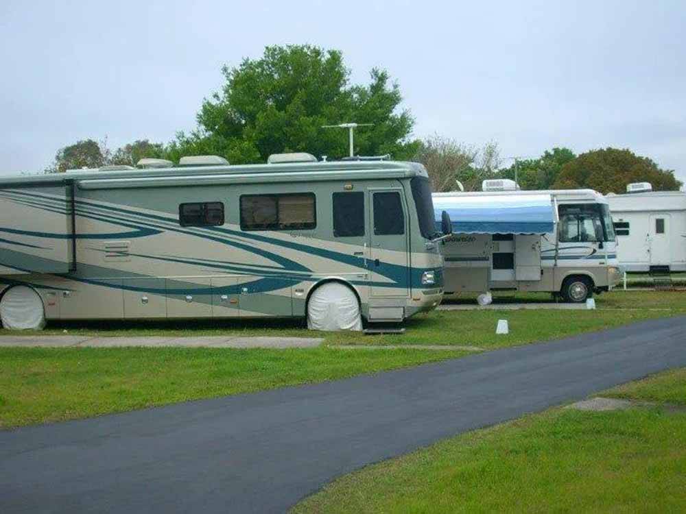 A line of motorhomes in sites at TICE COURTS & RV PARK