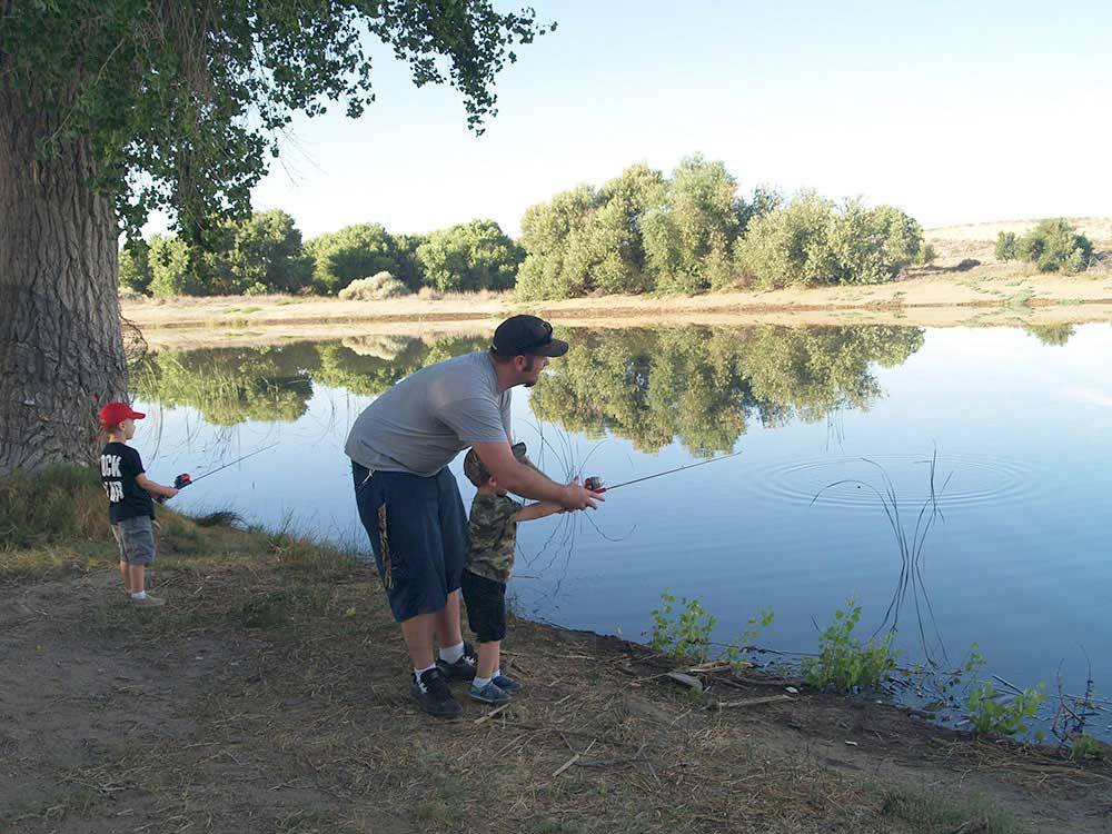 Father showing son how to fish at SAN BERNARDINO COUNTY REGIONAL PARKS
