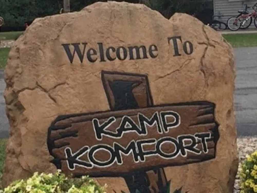 The front entrance sign painted on a rock at KAMP KOMFORT RV PARK & CAMPGROUND