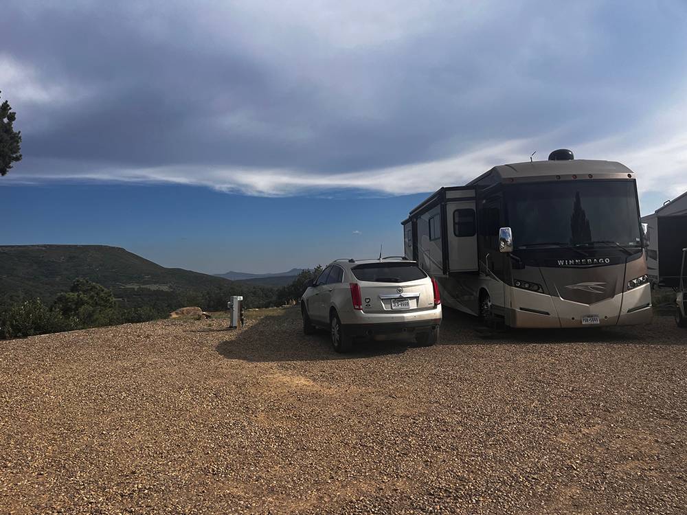 An RV and vehicle at a site