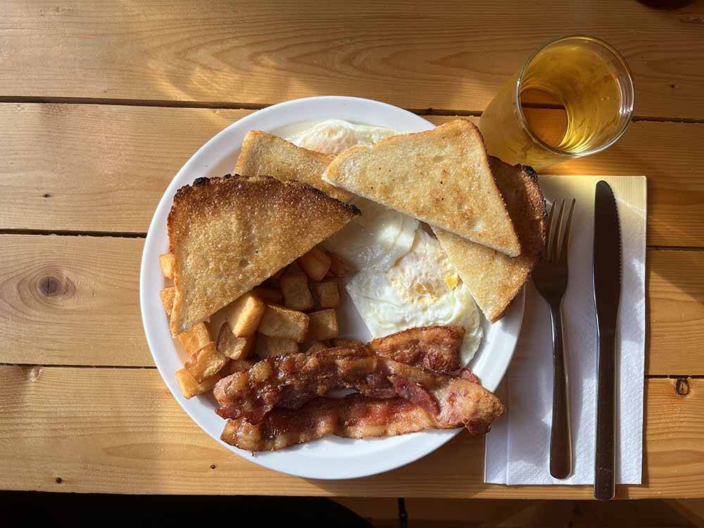 A plate of bacon, eggs, and toast at VIKING RV PARK