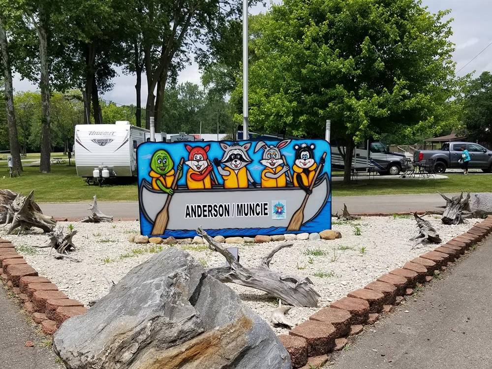 A sign with animal face cut outs at MUNCIE RV RESORT BY RJOURNEY