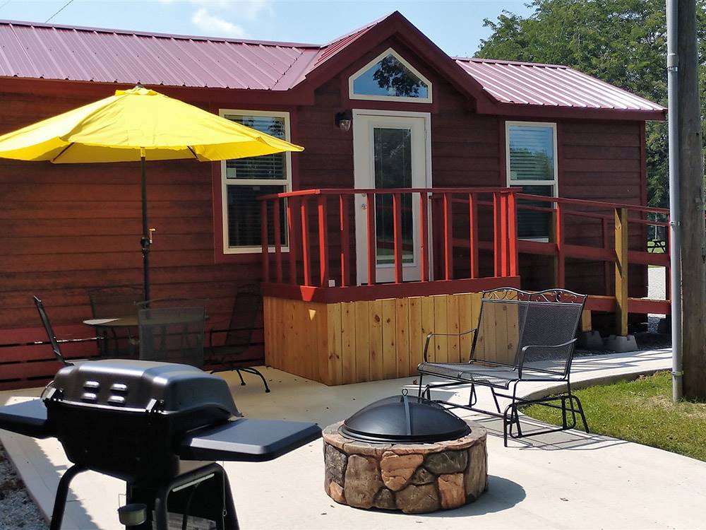 A cabin with fire pit and bbq pit at MUNCIE RV RESORT BY RJOURNEY