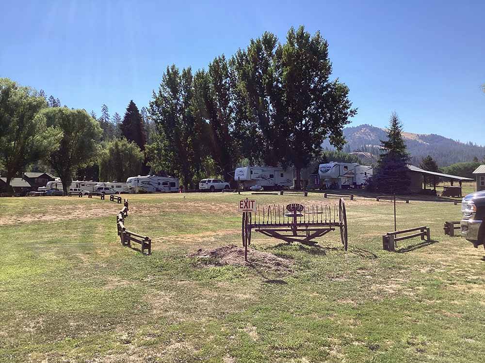 RVs parked next to a large green area at LONG CAMP RV PARK