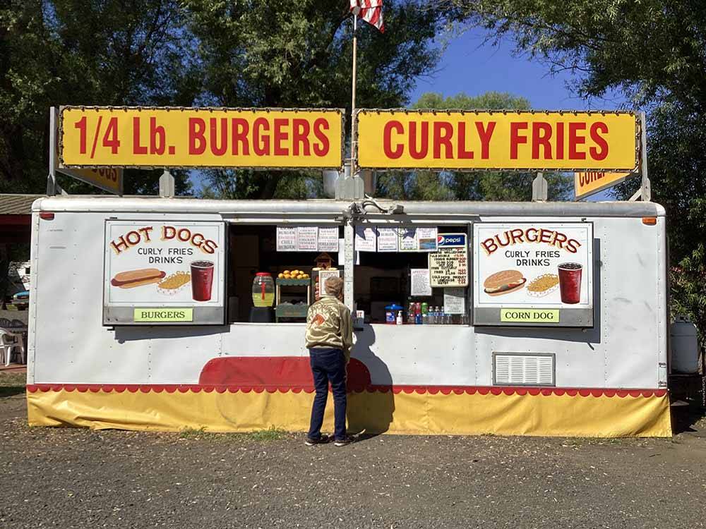 A burgers and curly fries stand at LONG CAMP RV PARK