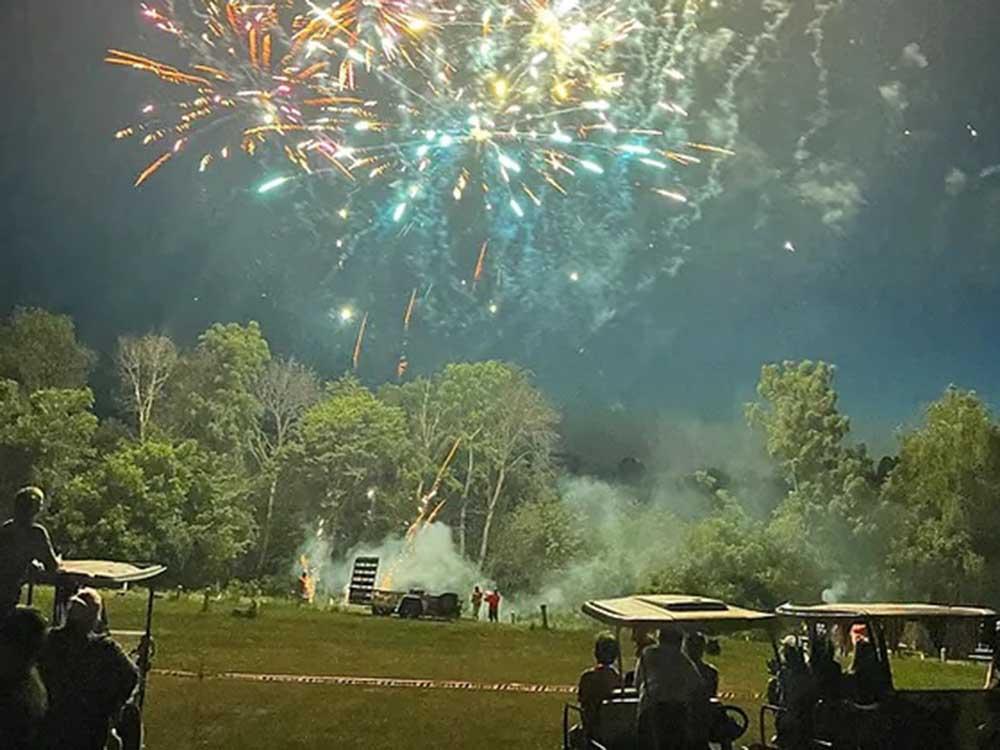 Campers enjoying a show of fireworks at WHITETAIL BLUFF CAMP & RESORT