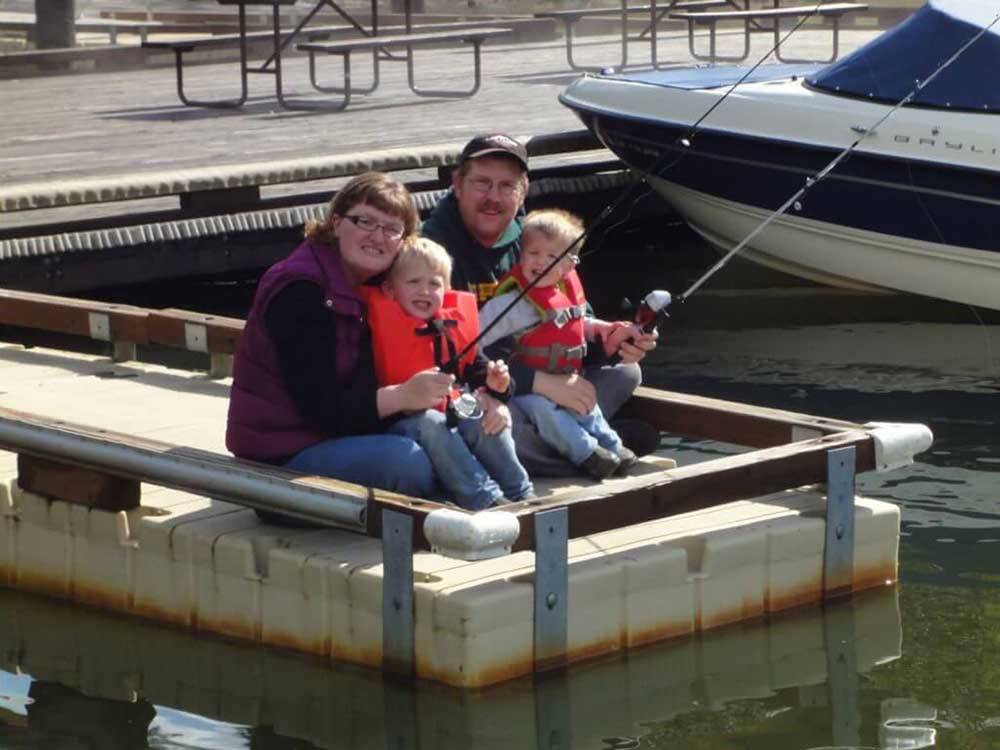 A family fishing off the dock at LOON LAKE LODGE & RV RESORT