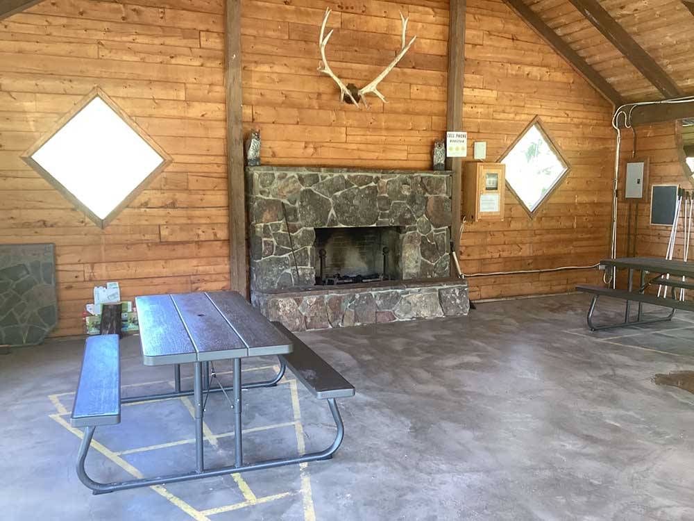 Picnic table near fireplace at GLACIER MEADOW RV PARK
