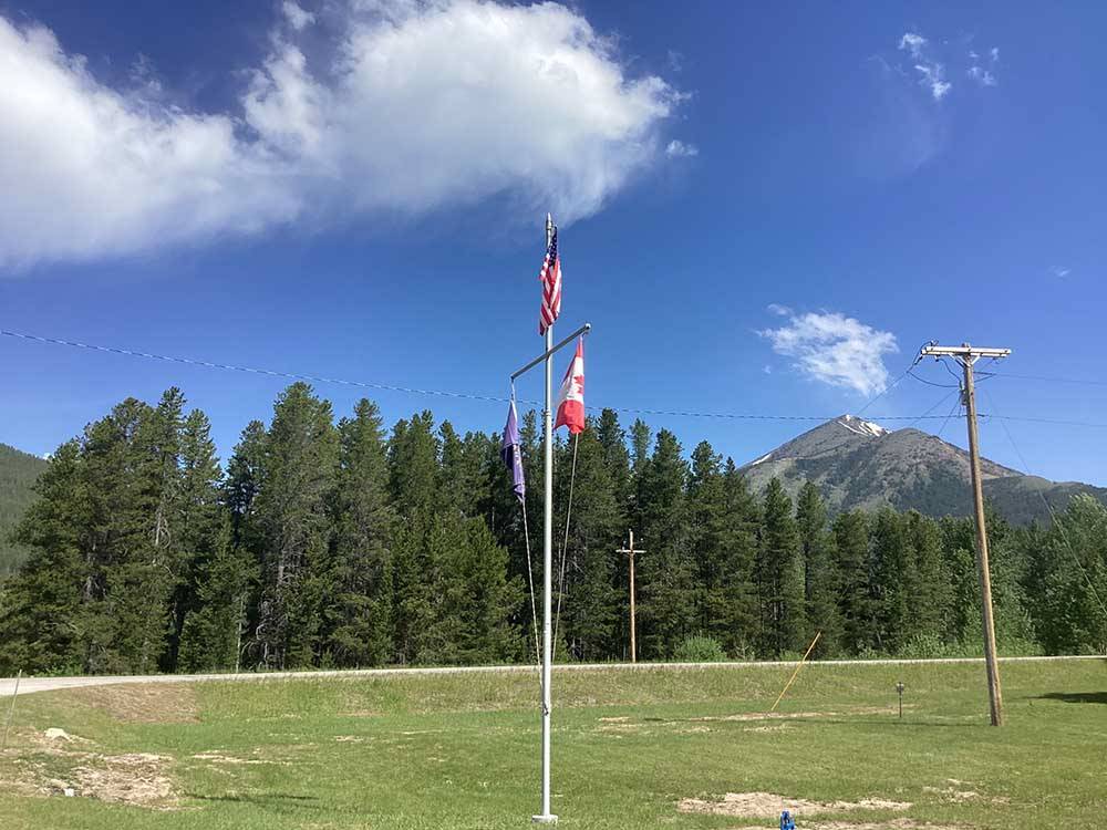 Flagpoles posted near campsites at GLACIER MEADOW RV PARK
