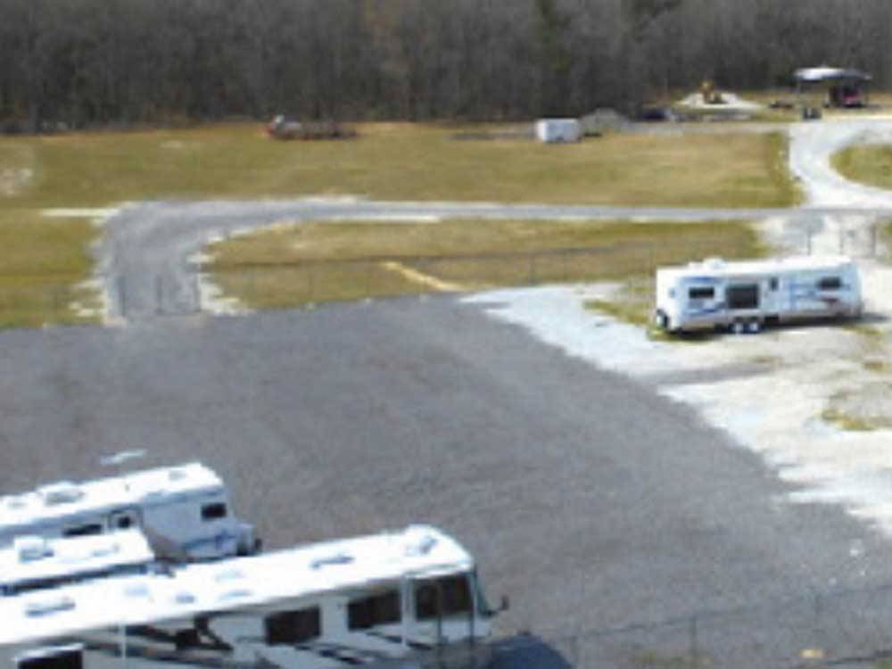 Motorhome and trailers parked in the storage area at JOLLY ACRES RV PARK & STORAGE