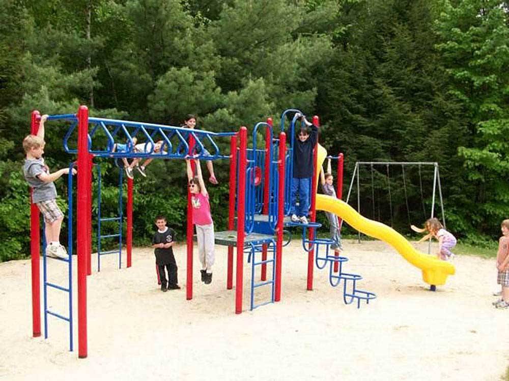 Playground with swing set at MEREDITH WOODS 4 SEASON CAMPING AREA