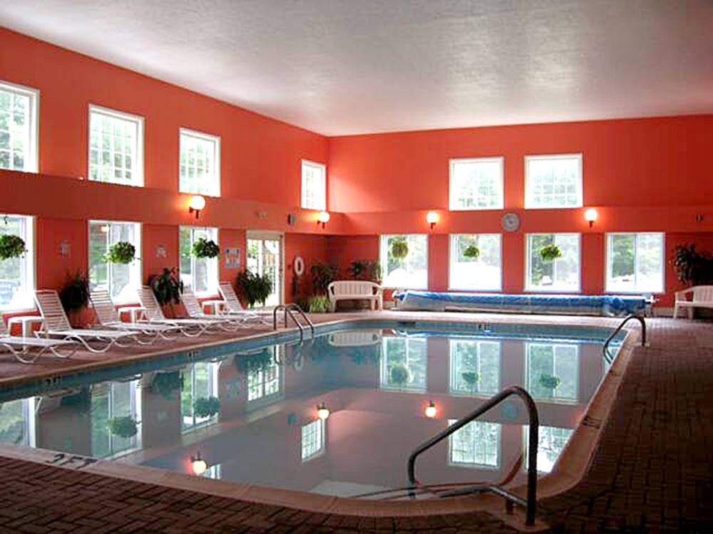 Large indoor pool with lounge chairs at MEREDITH WOODS 4 SEASON CAMPING AREA