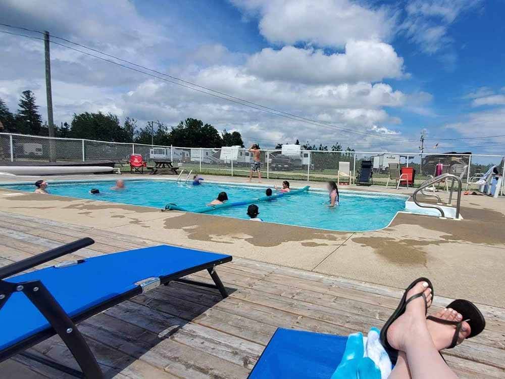 A view of the pool from a lounge chair at OCEAN RIVER RV RESORT & CAMPGROUND
