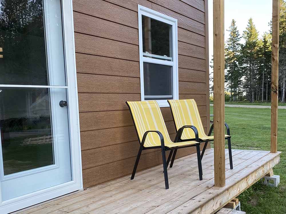 Outdoor chairs outside a rental unit at OCEAN RIVER RV RESORT & CAMPGROUND