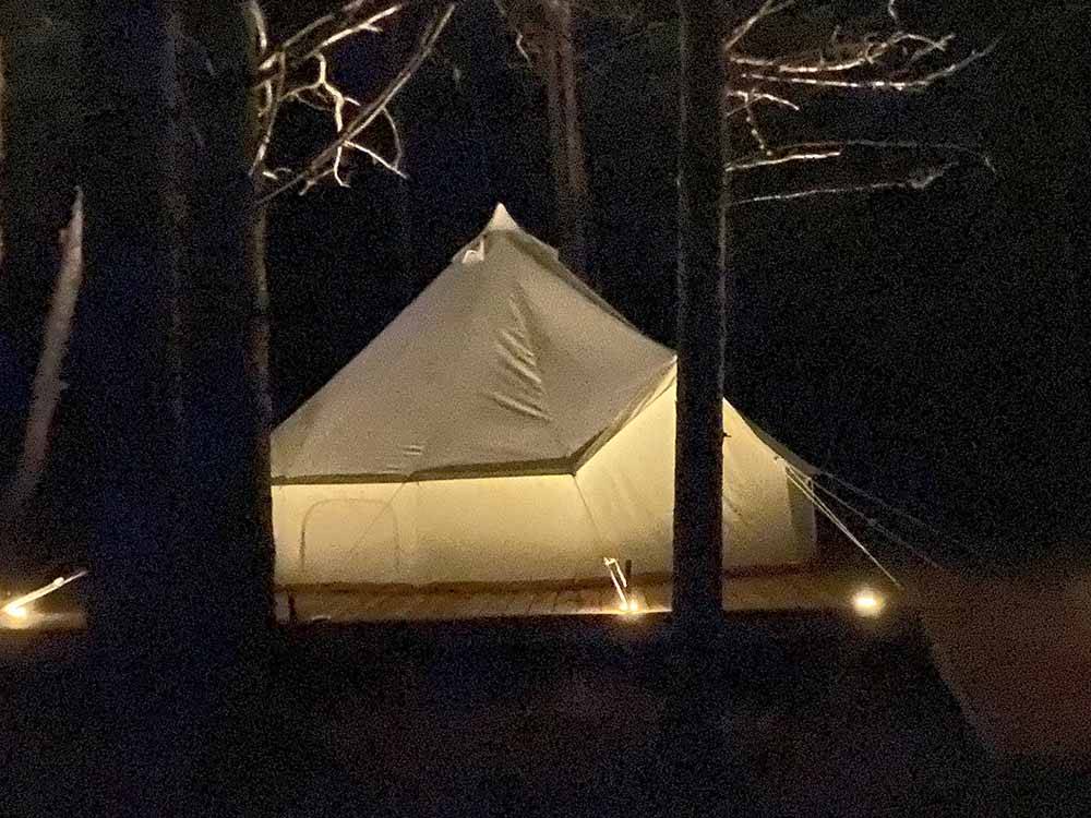 The view of a large tent at night at OCEAN RIVER RV RESORT & CAMPGROUND