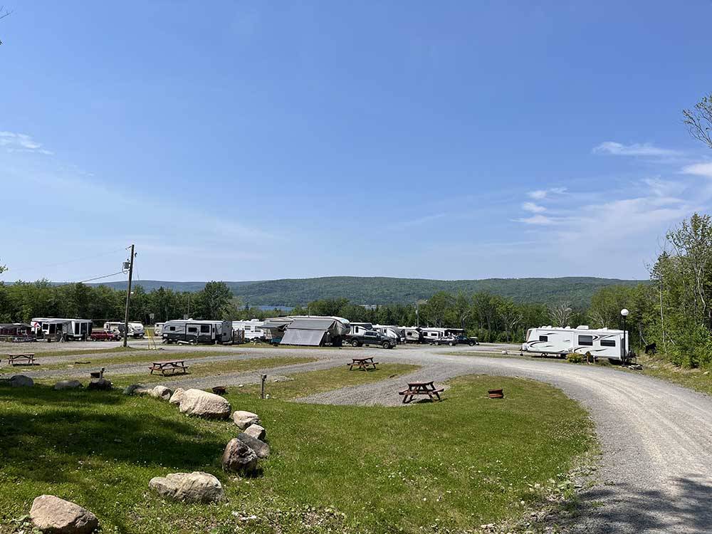 A group of gravel RV sites at ADVENTURES EAST CAMPGROUND & COTTAGES