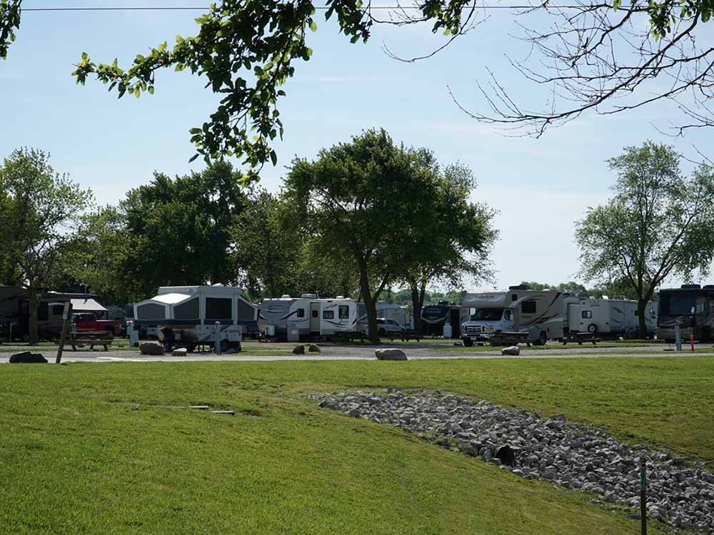Green grass with campers in background at LAKE HAVEN RETREAT