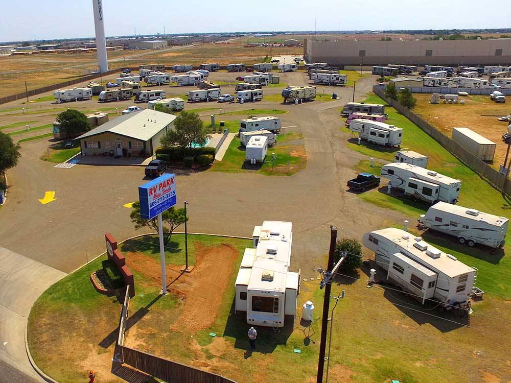 Overhead shot of entrance, office and sites with rigs at MESA VERDE RV PARK