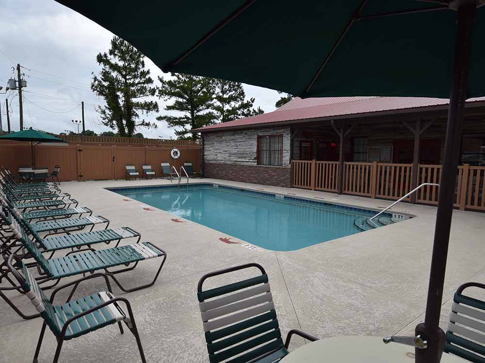 Seating around the swimming pool at WILD FRONTIER RV RESORT